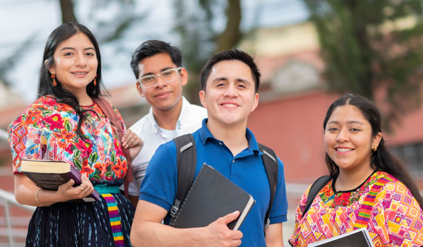 a group of Native American students holding textbooks