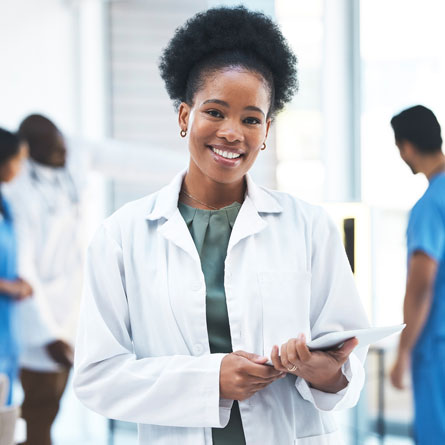 A female medical worker in a lab coat.