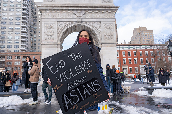 Protestor holds a sign at the End the Violence Towards Asians rally.