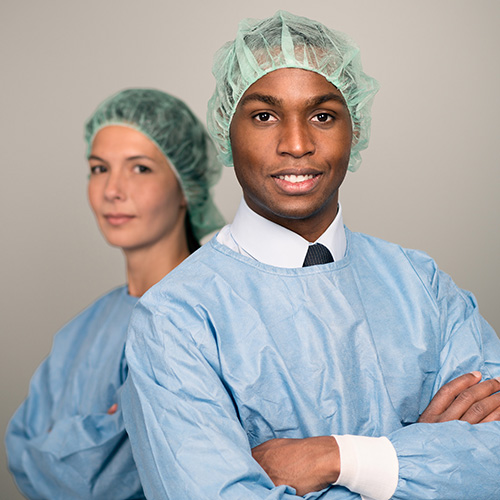 A man and a woman wearing medical scrubs.