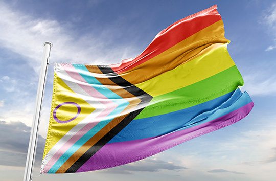 The Inclusive Pride Flag blows in the wind.