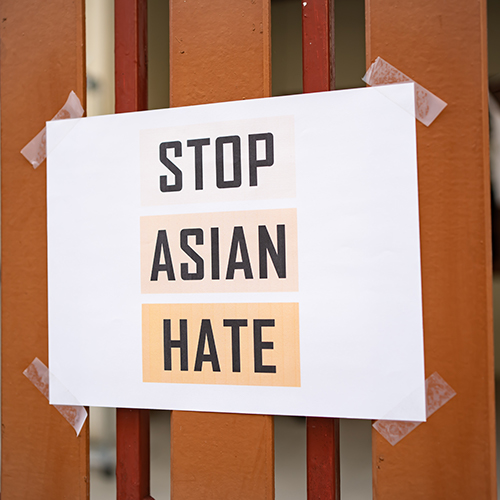Stop Asian Hate sign taped to a fence