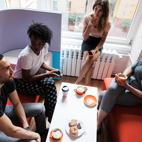 A group of 4 sitting and talking in a small space