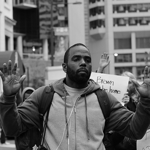  Black and white picture of black man with his hands up
