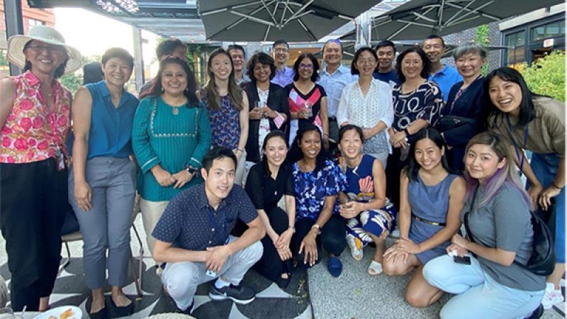 NIH’s FAN members gathered under two grey umbrellas for an informal networking event.