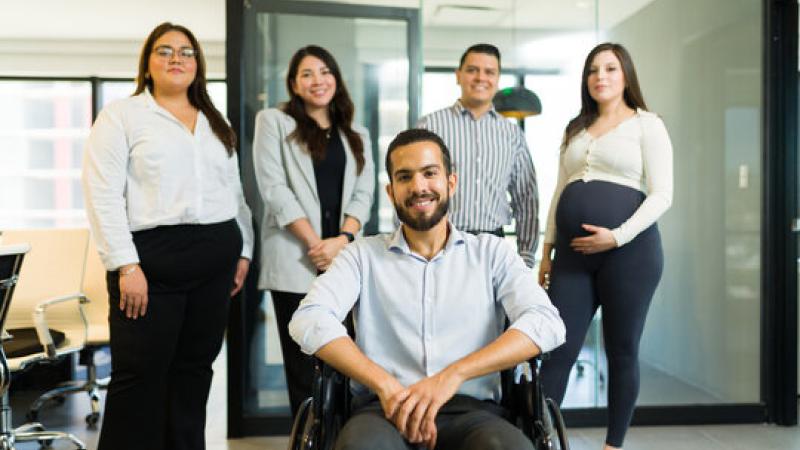 Group of Hispanic/Latin American professionals smiling in the office.